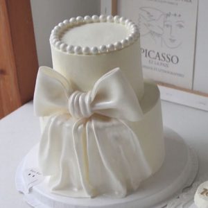 Two-tier White Ribbon Cake with Pearls on Top